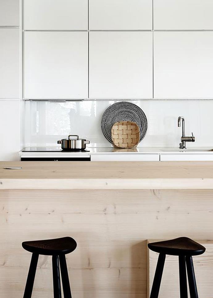 The open-plan kitchen in this [Scandi-inspired timber cabin](http://www.homestolove.com.au/a-scandinavian-inspired-timber-cabin-4561) is pared-back and simple, with smooth, handleless cabinets. Photo: Krista Keltanen