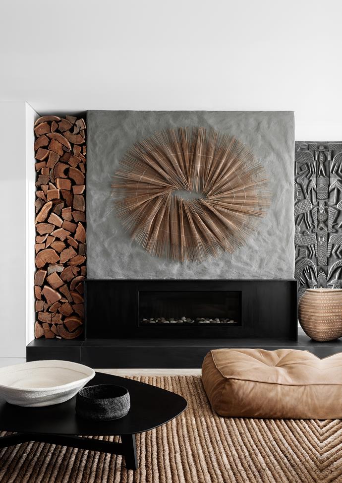 The fireplace surround is in honed black basalt. A Jardan ‘Alby’ leather ottoman sit on a ‘Manzanilla Malay’ abaca rug from International Floorcoverings. Wall installation by Tracey Deep.