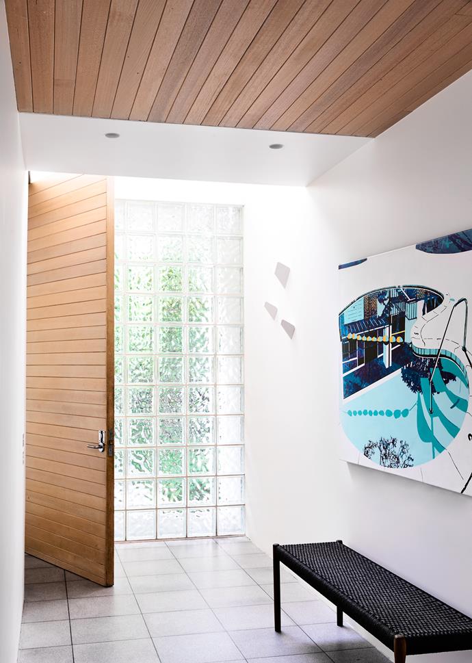 “We loved the original timber ceiling and glass bricks. They don’t appeal to a lot of people as many prefer a more traditional-style house,” says the home’s designer Mardi Doherty. Artwork by Paul Davies.