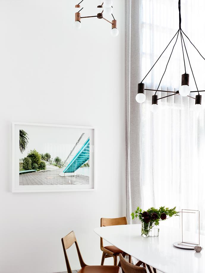 High Key Tokyo photographic artwork by Derek Swalwell adds a touch of turquoise to the clean white palette of the dining area. A Walter Knoll ‘Seito’ table is teamed with Danish chairs from Grandfather’s Axe. ‘Emry’ pendant from Jardan.
