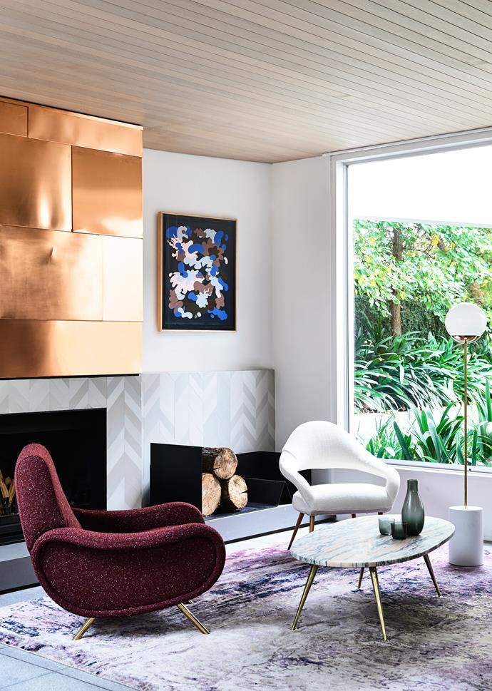 Copper sheeting, from George White, on the fireplace brings a touch of metallic glamour to the sophisticated living space. Mutina ‘Mews’ chevron fireplace tiles in Fog from Urban Edge. Cassina ‘Lady’ chair (left) and Poltrona Frau ‘Letizia’ chair, both from Cult.