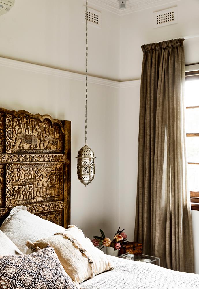 An intricate, hand-carved bedhead from Shikara Design in Byron Bay is the crowning glory of the master bedroom. Neutral-coloured bedlinen from restoration hardware. The Moroccan pendant light is from Ha'veli.