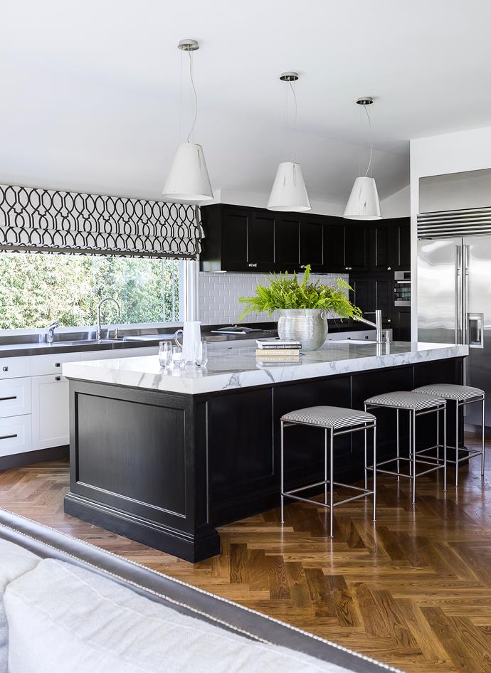 The refurbished kitchen is lovely and light, with plenty of storage, prep space and room to mingle. Joinery throughout, by Wyer+Craw. Carrara marble and stainless-steel benchtops. ‘San Remo’ stools from Tecno Furniture, personalised with striped seats.