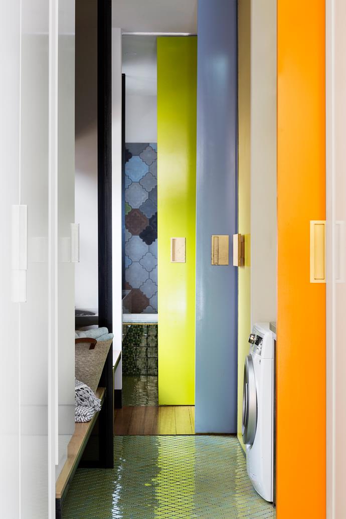 Timber gives way to feature tiles and flashes of fruit-inspired colour on the sliding doors.