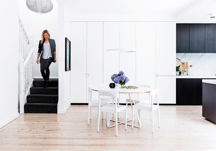 Kristy (pictured) helped to get the right balance in materials and colours in the spaces. The all-white dining room is perfectly bookended by darker [kitchen cabinetry](https://www.homestolove.com.au/kitchen-cabinets-your-guide-to-choosing-right-5610|target="_blank") and carpeted stairs.