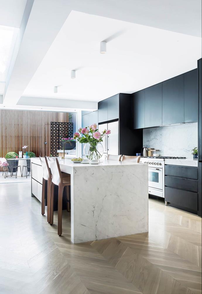 In a classic Parisian fashion, this [Victorian terrace](http://www.homestolove.com.au/classic-parisian-style-unifies-a-victorian-terrace-4730) juxtaposes white marble with a neutral floor and inky cabinets, creating a moody kitchen that blends seamlessly with an outdoor courtyard. 
*Photo: Maree Homer*