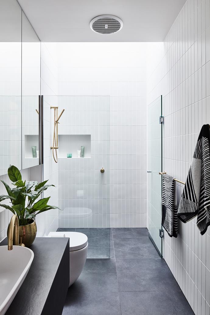 The bathroom and laundry both feature 600mm porcelain floor tiles in Charcoal and 60mm x 240mm ceramic wall tiles in Matte White. Tapware and hardware from Sussex Taps.