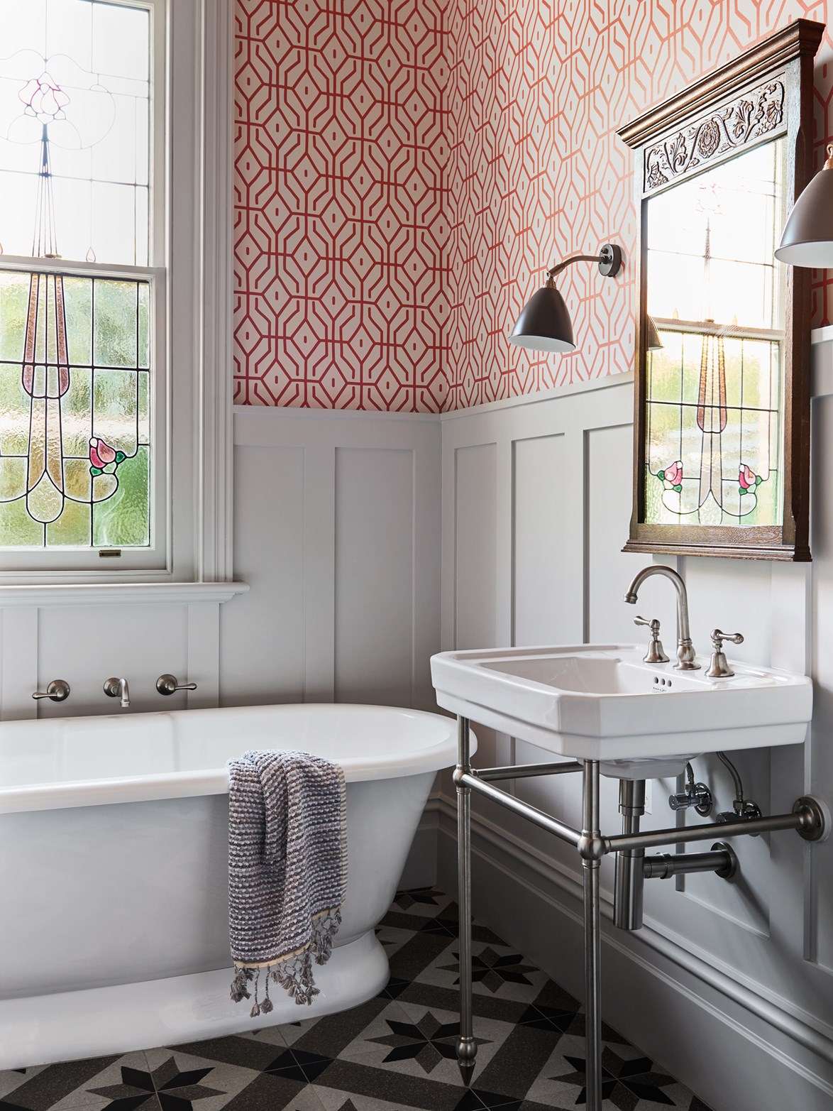 Inspired by the work of Ilse Crawford and without the need to include a shower, [this chic bathroom](https://www.homestolove.com.au/8-bathrooms-with-a-hint-of-glamour-1-6024|target="_blank") was treated with more decorative 'dry' finishes around the freestanding bathtub, with striking geometric wallpaper and a chrome basin stand to add personality without cramping the space.