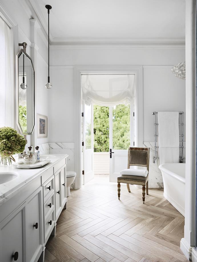 To complement its classic setting, this grand ensuite by [Thomas Hamel & Associates](https://thomashamel.com/ |target="_blank"|rel="nofollow")was washed in light and given a glamorous makeover. “Using the space as a blank canvas, we focused on detailing to complement the grandeur of the Federation home by introducing marble wall panelling and painted walls to add scale, faux wood ceramic floor tiles and incorporating light through contemporary fittings and sunshine,” says designer Thomas Hamel. *Photo: Anson Smart*