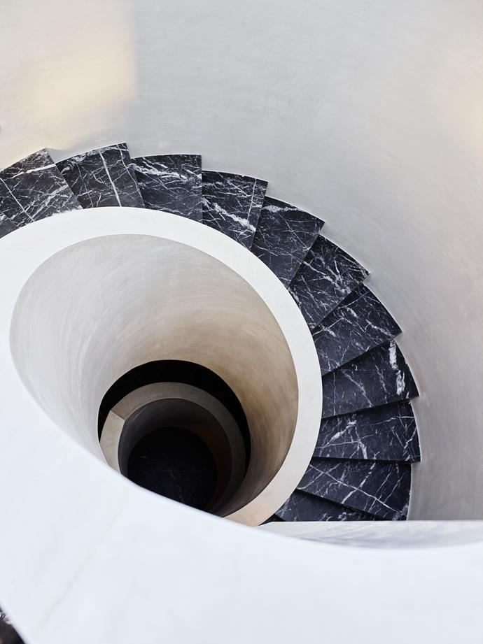 Rob Mills's signature design element – the spiral staircase – is executed in black marble and lit by a circular skylight.