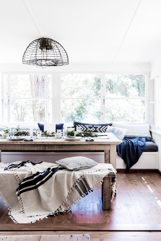 Tasselled linen throw rugs make for a cosy, inviting dining room setting. This [nautical inspired beach shack](https://www.homestolove.com.au/a-nautical-inspired-beach-shack-north-of-sydney-6175|target="_blank") north of Sydney nails relaxed, coastal styling and is perfect for the homeowners' young family. *Photo: Maree Homer / Story: real living*