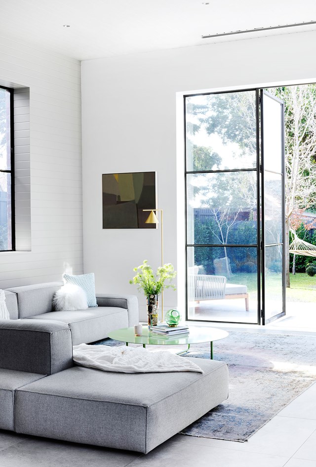 Black steel-framed windows and doors create a modern industrial feel.