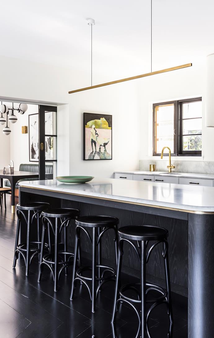 Marble-topped kitchen island with brass detailing.
Bentwood stools from Thonet. Brass lightfitting by Rakumba.
Artwork by Emilie Syme-Lamont from Curatorial+Co.