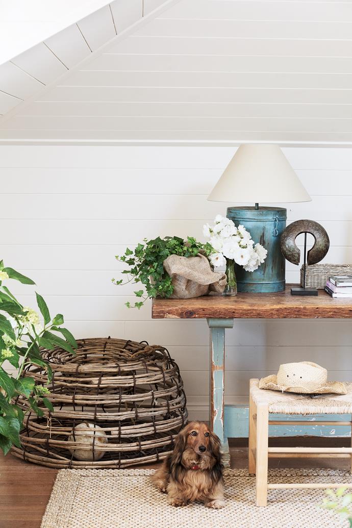 Guests love staying in this country-inspired space, surrounded by curiosities and plants. It also has a Juliet balcony. The oyster fishing basket and tin lamp bases are from a local antique dealer. Barnaby likes the sisal rug.