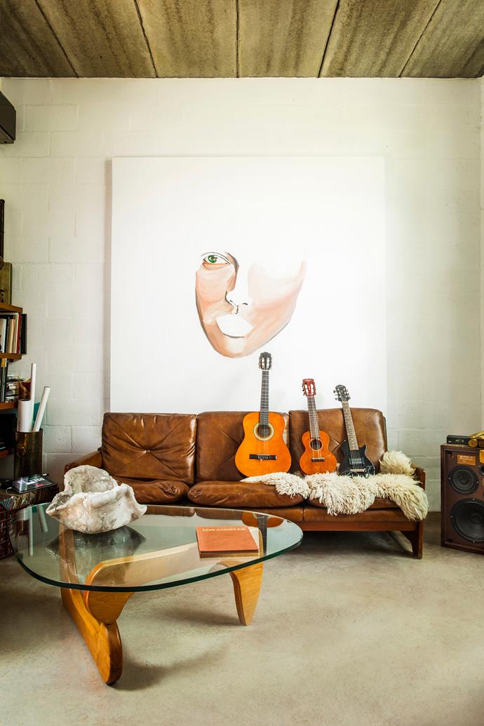 The open-plan living room is flooded with natural light. The homeowners have devoted this room to painting and music.