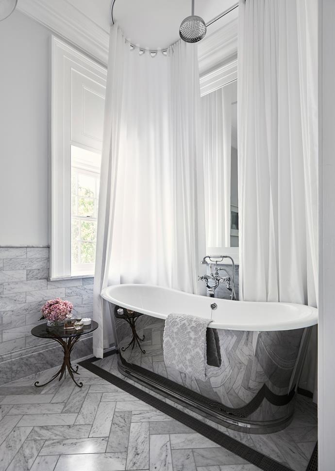 The highlight of this luxe ensuite is the bath with custom chrome finish.