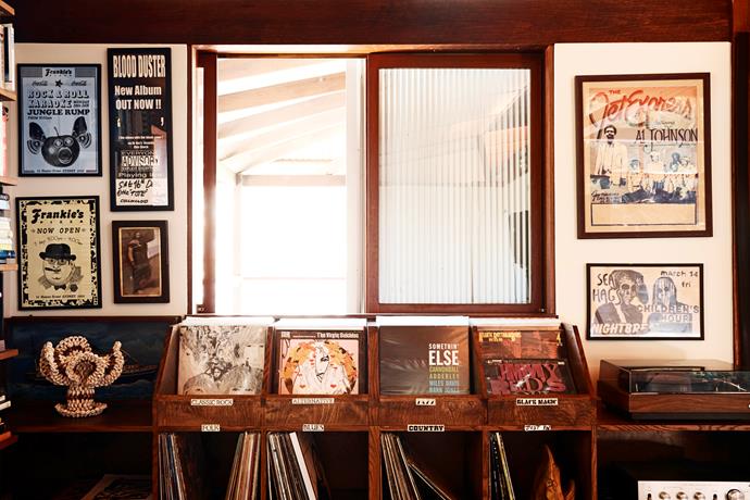 The couple keep their extensive record collection in a custom-made cabinet. "We wanted something to easily flick through, like you do in record stores," Allie says. The posters above are from the couple's venue Frankie's Pizza and a junk store in Memphis.