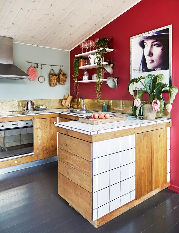 The kitchen was designed and built by the couple themselves, using high-glazed tiles and oak wood. The poster on the wall is the cover of Cecilie's first album.