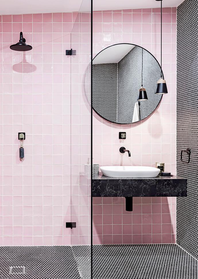 White grout gives bathrooms a Scandi-style edge. Here, black Penny Round tiles and matte black accents allow the bathroom's pink to pop.

*Photo: Maree Homer / Bauersyndication.com.au*