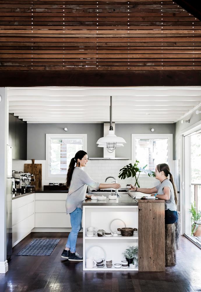 Vrinda and Gopi in the bright and welcoming space Vrinda designed. "My only disappointment is that I didn't go with a double sink," she says. Gavin made the breakfast bar from salvaged wharf timbers, and the stools from an old gum tree.