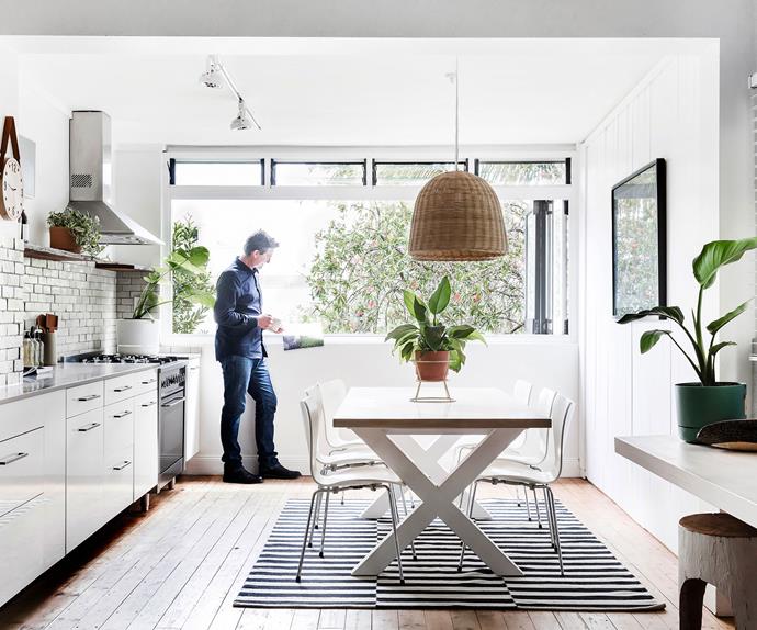 Russel Koskela enjoying a hot drink in the kitchen / dining area of his home in Sydney.