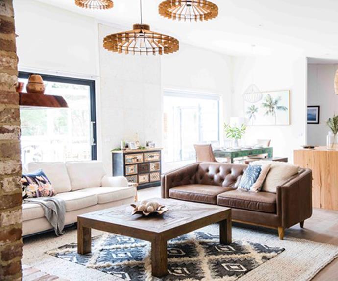 Coastal style living room with sisal rug and leather couch