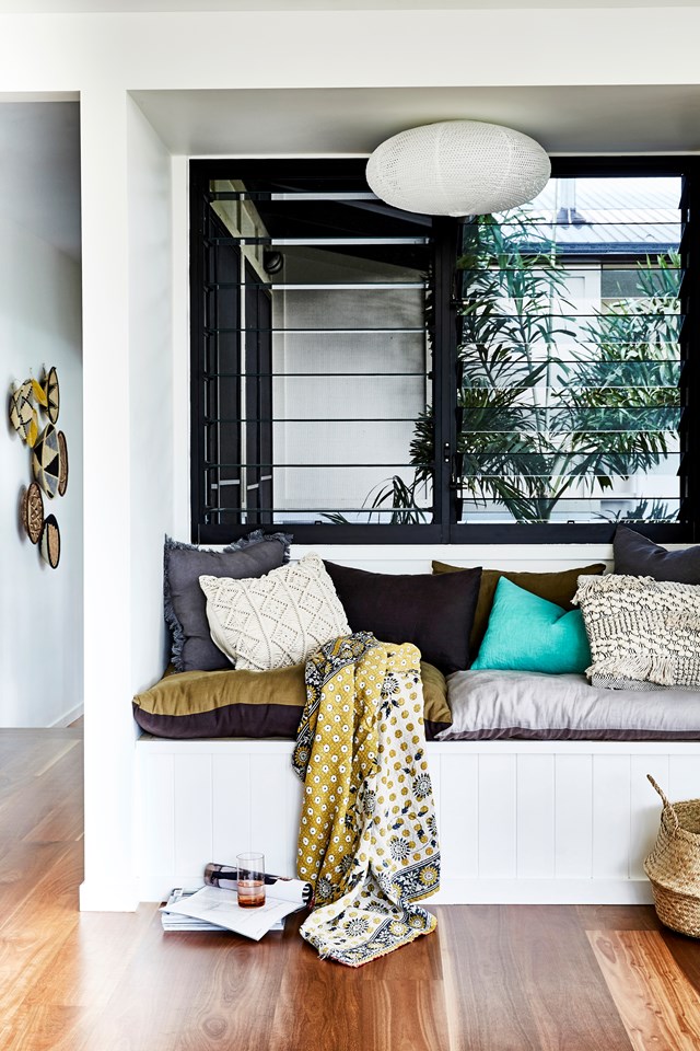 This built-in daybed was the perfect solutions for converting wasted space into a chill zone. "It's a great spot to relax and catch the breeze", says Lauren - the owner of this [tranquil home in Tallebudgera Valley, Queensland](https://www.homestolove.com.au/lessons-learned-from-a-real-life-tree-change-6808|target="_blank"). Cushion covers and throws from I Love Linen provide cosiness and there is generous storage space underneath. *Photo:* Kristina Soljo