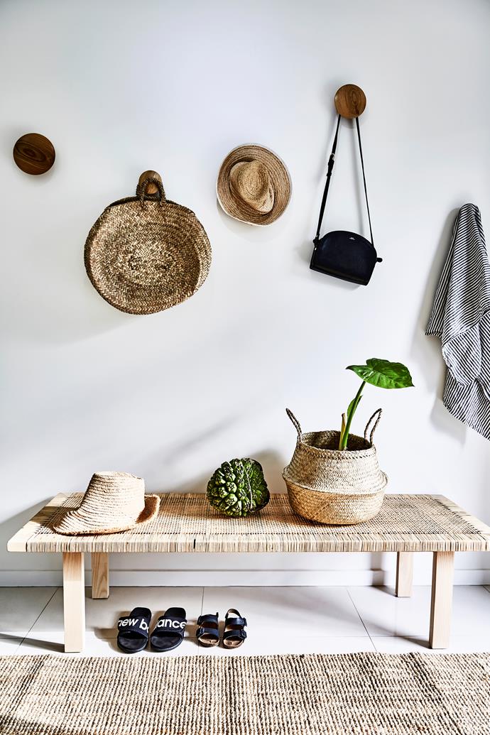 The [mud room](https://www.homestolove.com.au/mudroom-design-6620|target="_blank") near the entry features a rattan Stockholm coffee table from Ikea and African woven baskets from Trader Trove. The walls are painted in Dulux Vivid White
