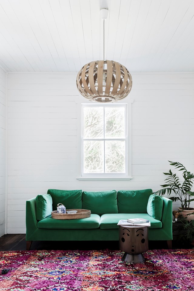This emerald green velvet sofa looks like the perfect place to curl up.