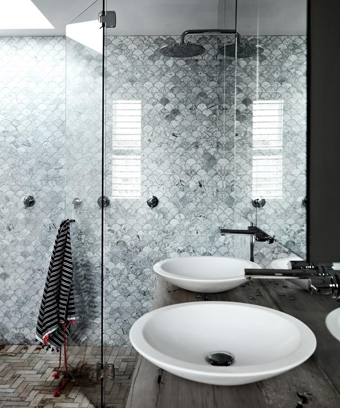 Contrasted with a dark wooden vanity, grey Carrara fan-shaped tiles add depth and opulence to this skylight-lit bathroom. *Photo: Sharyn Cairns / Bauersyndication.com.au*