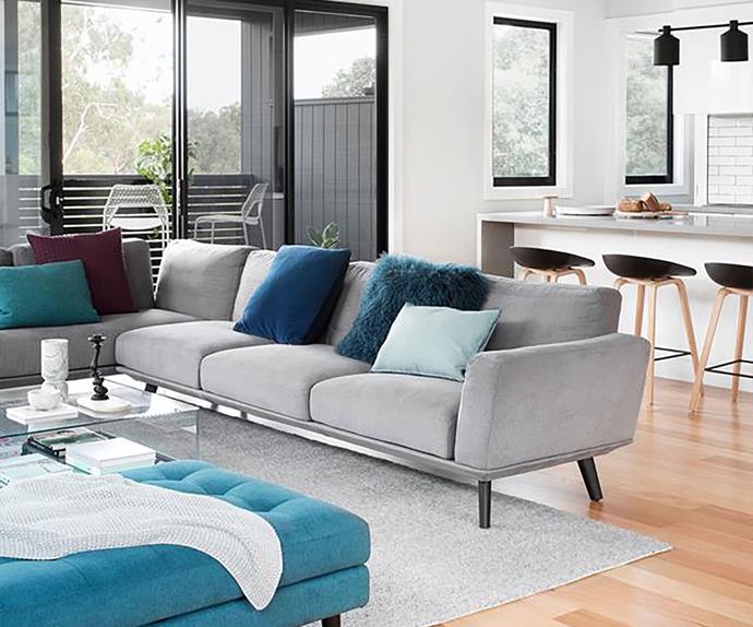 Scandi style living room with grey sofa and blue accent colours