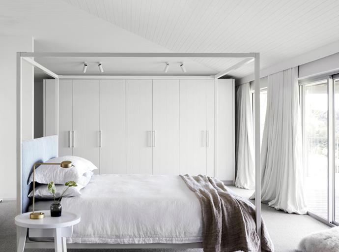 The master bedroom  has a four-poster bed from Incy Interiors with a custom bedboard in Thibaut 'Essex Velvet' in Cloud from Boyac. Gervasoni 'Gray' bedside table.