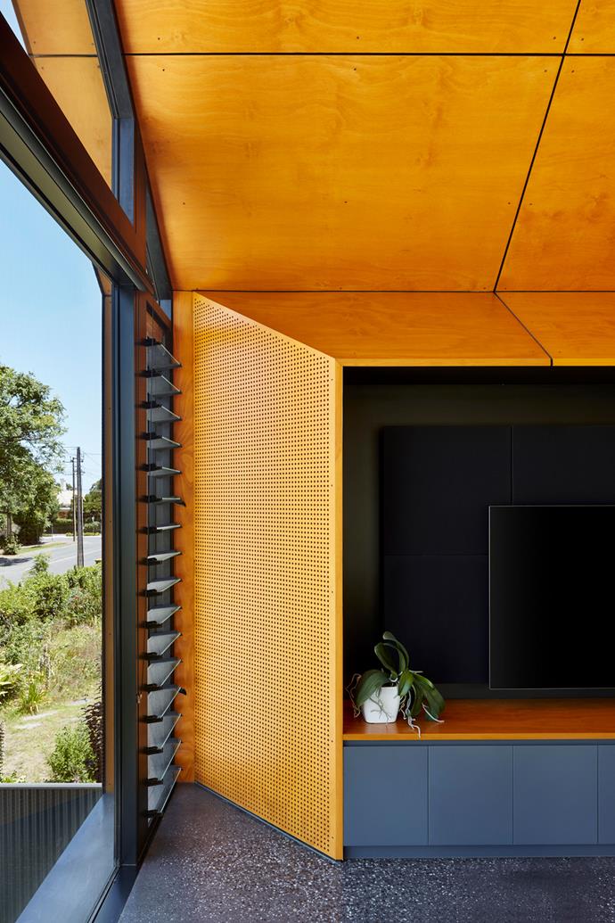 Golden-toned plywood cladding folds into the TV cabinet to create a consistent look and feel.