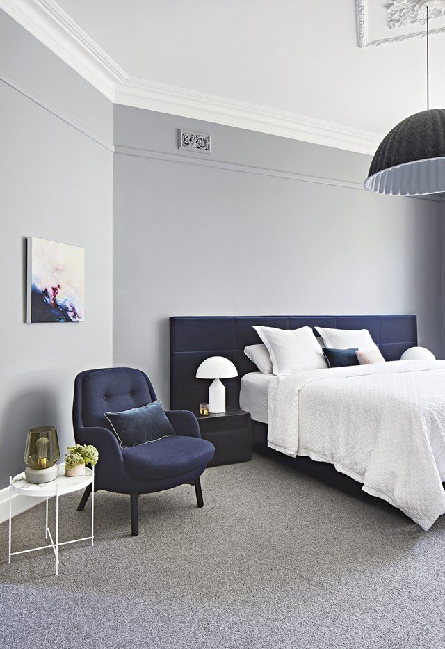 A palette of soft grey, navy and white creates a tranquil mood in the master bedroom of this [century-old Edwardian home](https://www.homestolove.com.au/a-modern-extension-revived-this-century-old-edwardian-home-7147|target="_blank") while an oversized custom bedhead adds a sense of modern luxury. Interior design: Josie Camilleri