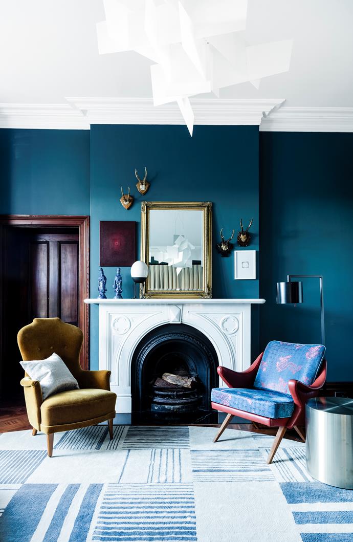 The impressive scale of this space, the ample light and water view allowed me to wash the walls in deep blue," says Brett. Vintage chairs from Our Space Interiors covered in textiles from South Pacific Fabrics and leather from Pelle Leathers. '
