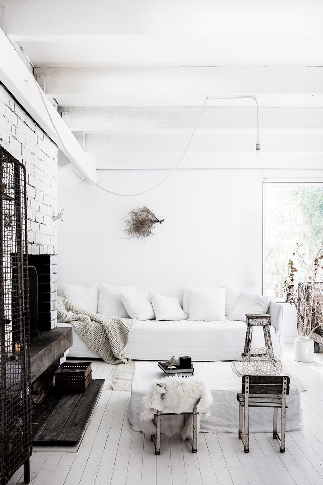 Every surface of this [coastal meets French Provincial home](https://www.homestolove.com.au/coastal-french-provincial-home-7155|target="_blank") has been painted white. By bringing in some natural elements – timber, twigs, dried flowers, shells, ceramics – for warmth and visual interest, the home feels anything but cold and sterile.