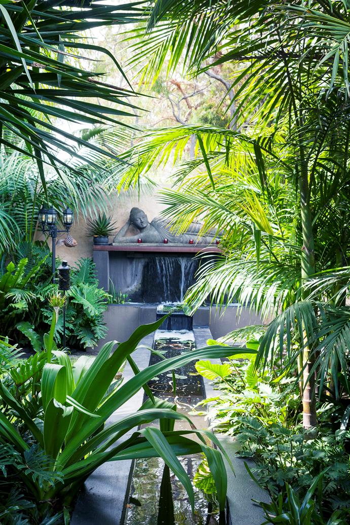 **Create a serene atmosphere**
<br></br>
Tropical rainforests aren't often associated with suburban Melbourne, but that's exactly the type of [garden landscaper John Couch](https://www.homestolove.com.au/tropical-garden-melbourne-7183|target="_blank") has created at his own home. A water feature winds through lush, emerald foliage and instantly transports visitors to another world.