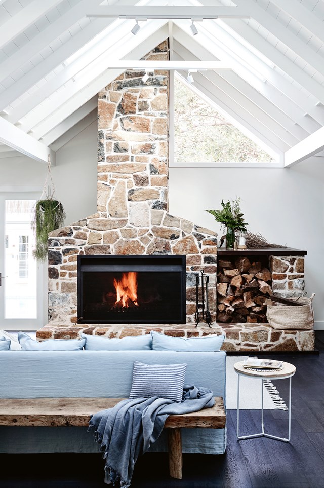 In true [country farmhouse style](https://www.homestolove.com.au/coastal-farmhouse-reno-gerringong-18827|target="_blank"), this enormous fireplace dominates the living area, towering to the top of vaulted ceilings to draw the eye upwards. A generous hearth is both functional and beautiful, setting the scene for visitors to congregate here.