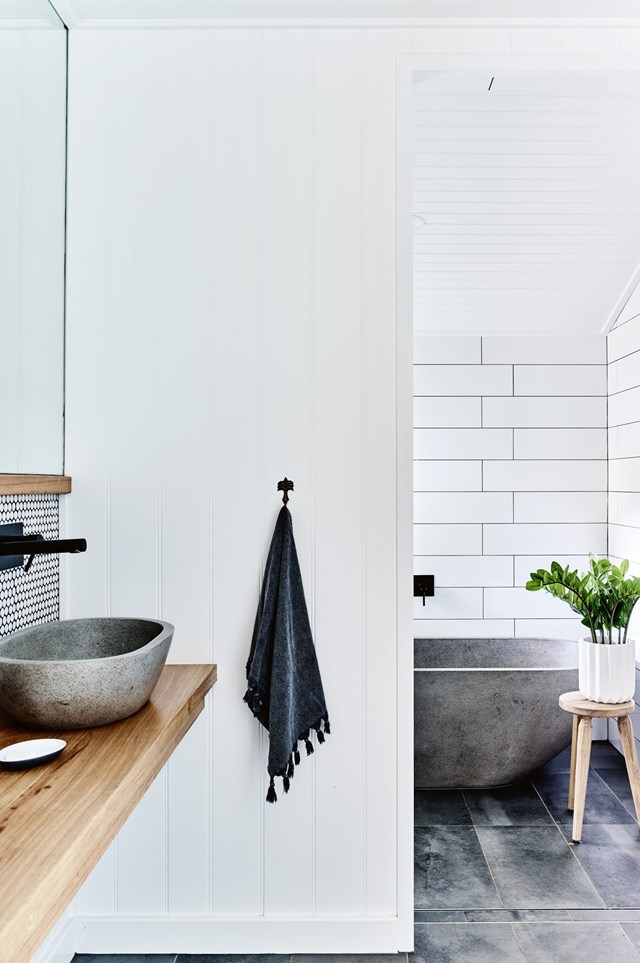In this bathroom, relaxed textures such as stone and timber have been paired with features quintessential to a country aesthetic, including subway tiles and [beadboard panelling](https://www.homestolove.com.au/kitchen-cabinet-door-styles-7021|target="_blank").