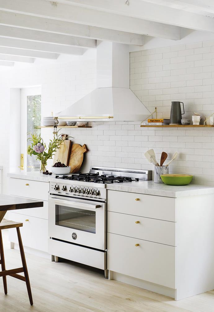 **Kitchen** The rustic look comes through in simple painted cabinetry with a marble benchtop, bleached oak floors and a subway-tiled wall, offset by a Bertazzoni cooker and rangehood.