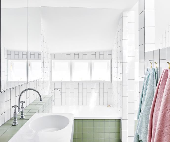 **Divide and conquer**<br>
Pistachio-green and white tiles balance this stripped-back space. The bold base of green gives way to vertical white subway tiles, making the space look larger and brighter at eye-height, and creating the illusion of higher ceilings.