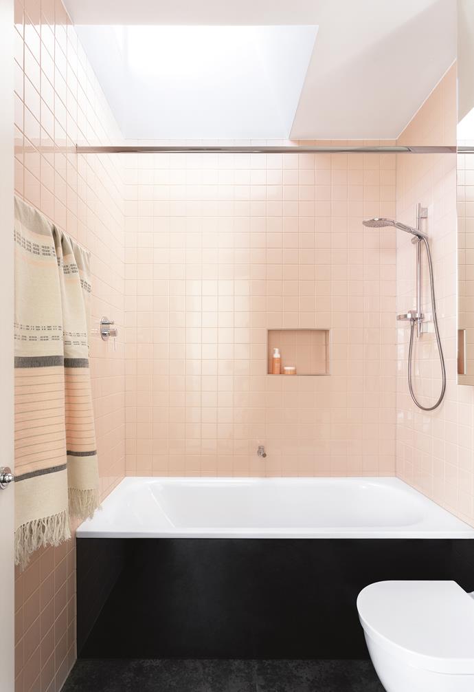 **Peachy keen**<br>
Dusty-pink tiles make this the ultimate feminine space. A skylight and large mirrored cabinet keep the entire room feeling bright and open, bouncing light off the tiled walls. A recessed shelf is a streamlined solution.