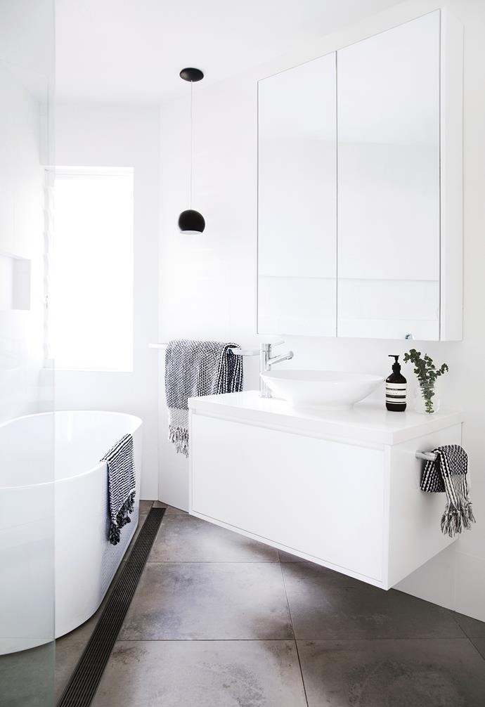 **Puzzle out**<br>
This design manages to fit a bath, shower, toilet and vanity into an odd-shaped room. "We drew it all out with spray paint on the floor," says homeowner Sophie. "While it's small, we've been able to fit a lot in."