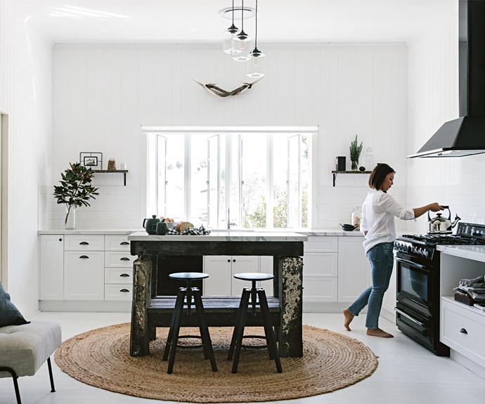 Maree puts the kettle on in the light-filled kitchen. The island bench is tallowwood, topped with [Smartstone](http://www.smartstone.com.au/|target="_blank"|rel="nofollow") 'Statuario Venato' and the 'Dalfred' stools are from [IKEA](https://fave.co/2PWeV12|target="_blank"|rel="nofollow").