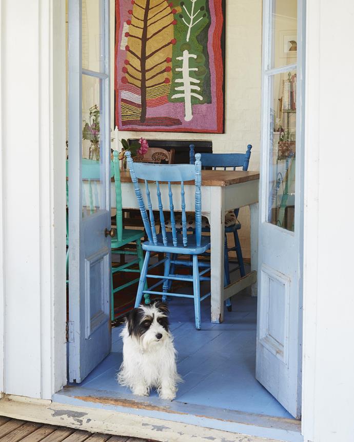Annie and Henry's long-haired Jack Russell terrier, Maggie, in the dining area. A Ray Ken painting from Alcastan Gallery, Melbourne, adorns the wall.