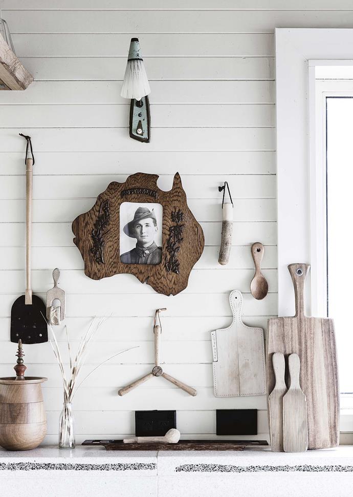 A collection of quirky Australiana homewares found in secondhand shops and on eBay — such these timber objects and a photo of an unknown soldier — add a layer of personality.