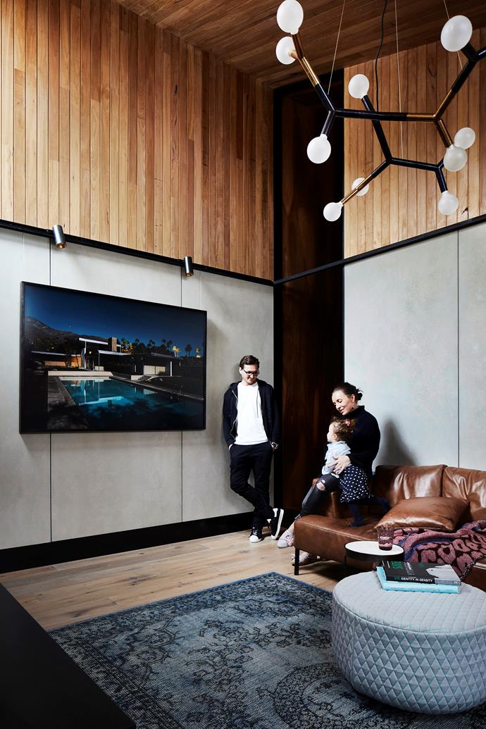 Michael and family love this contemporary corner, where a photograph by Tom Blachford presides. The walls are clad in silvertop ash and CSR fibre-cement panels. Sofa, Ross Didier. Ottoman/coffee table, Anaca Studio.