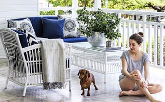 Woman and dachsund on a Hamptons style verandah