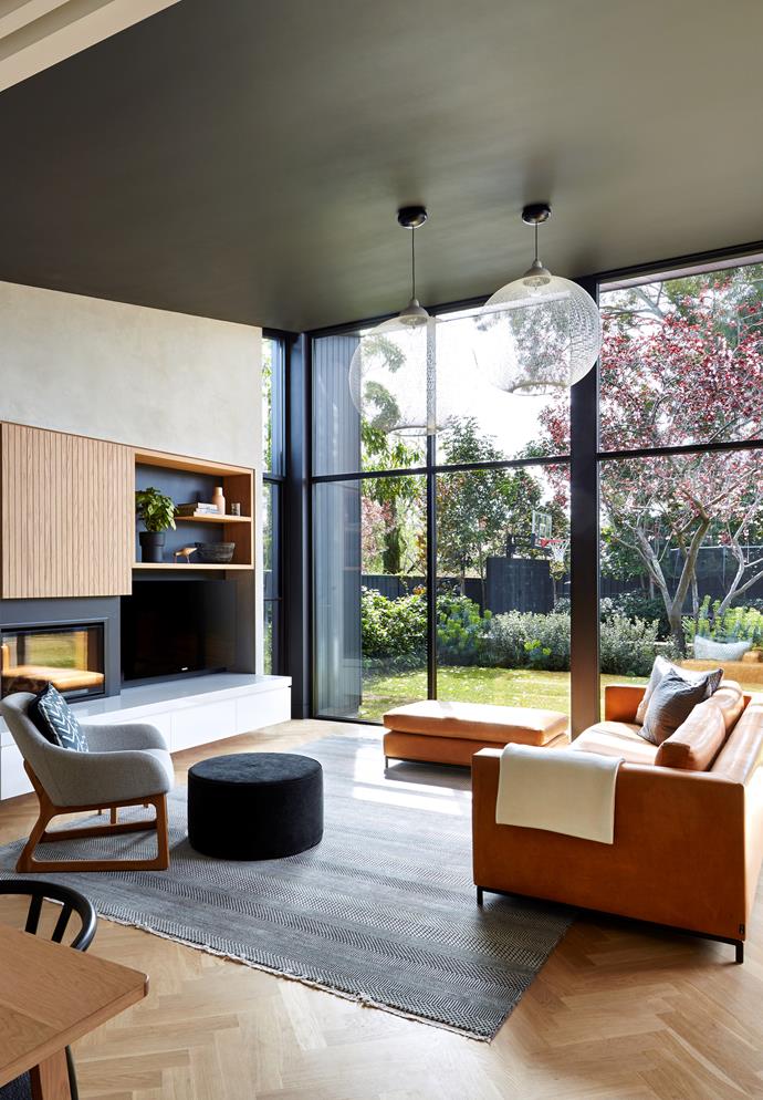 **'Personality plus by Rebecca Ryan Architect:** "The owners wanted to feel like they were sitting in the garden," says architect Rebecca Ryan, who was more than happy to run with the indoor-outdoor brief for this Adelaide family room, which is part of a larger open-plan space. Key to achieving this feel is the glazed rear wall (shaded by deep eaves), offering an almost-uninterrupted vista, and the room's floor level, perfectly in line with the lawn beyond. A pair of Moooi 'Non Random' pendant lights provides texture and interest without detracting from the leafy view. Built-in joinery ensures a place for everything. "It's all that we envisaged and more," says owner Sean. *Photo:* Sam Noonan
