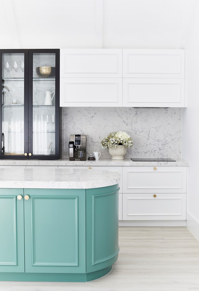 If dark neutrals aren't really your thing, why not make meal prep time an exciting affair and experiment with a unique hue like this soft teal. The white backdrop and black accents in this otherwise [minimalist space](https://www.homestolove.com.au/statement-kitchen-design-ideas-19238|target="_blank") really make the lower cabinets pop, creating a chic cooking zone. 

*Photography: Three Birds Renovation | Story: Homes To Love*
